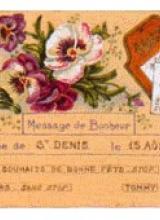 Carte télégramme sur papier orange, envoyé le 15 aout 1943. Des dessins de fleurs roses et blanches illustrent le texte.